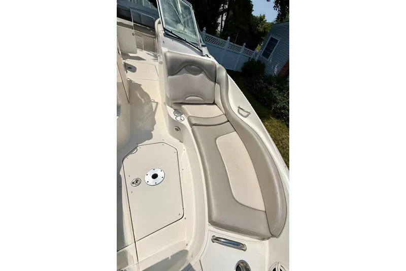 Slide: The Image of 2005 Sea Ray 270 Sundeck boat interior with cushioned seating and sleek design. - 15