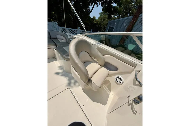 Slide: The Image of 2005 Sea Ray 270 Sundeck boat interior with beige seating and speaker. - 24