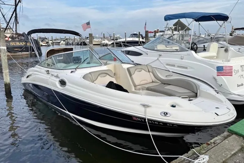 The Image of 2005 Sea Ray 270 Sundeck boat docked at marina with American flag. - 1