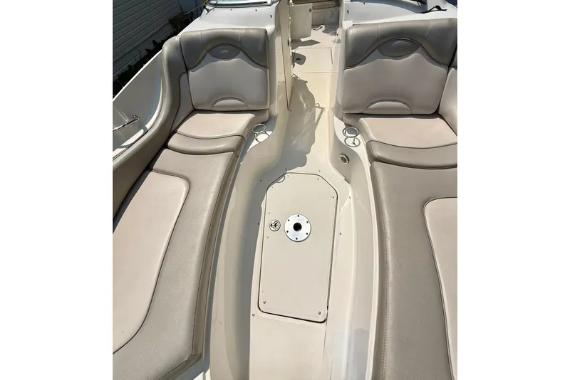 Slide: The Image of 2005 Sea Ray 270 Sundeck interior with beige seating and spacious layout. - 17