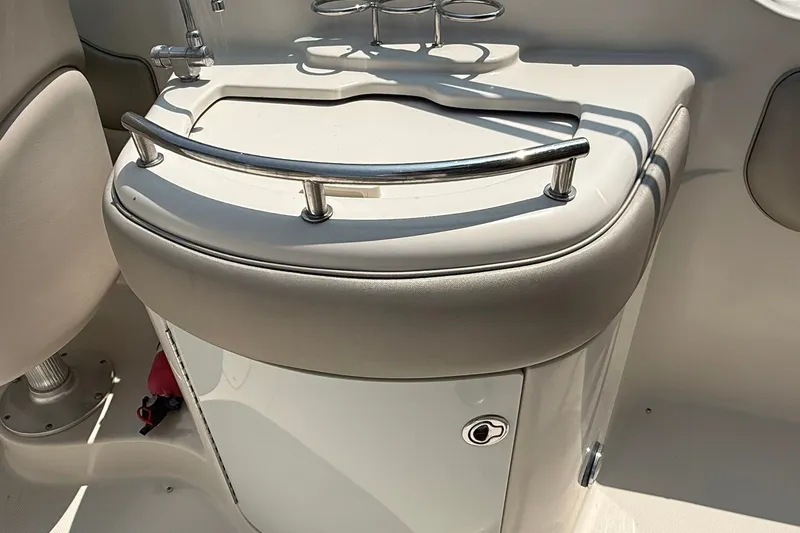 Slide: The Image of 2005 Sea Ray 270 Sundeck interior detail with cushioned seating and stainless steel railing. - 18