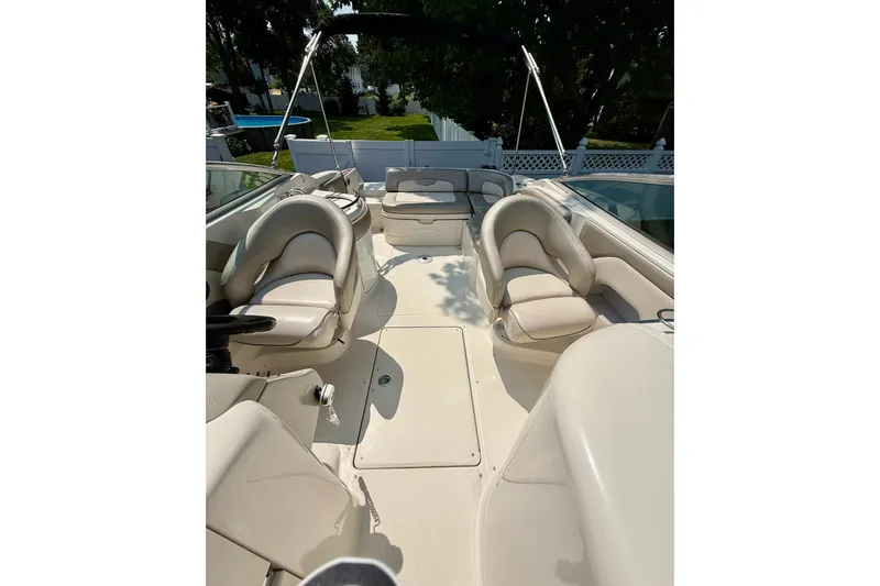 Slide: The Image of 2005 Sea Ray 270 Sundeck interior with plush seating and spacious layout. - 22