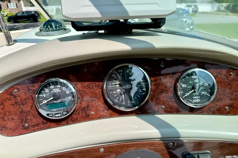 Slide: The Image of Dashboard of a 2005 Sea Ray 270 Sundeck boat with gauges and compass. - 7