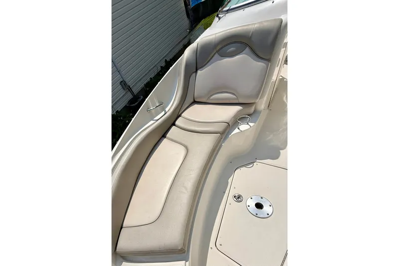 Slide: The Image of 2005 Sea Ray 270 Sundeck boat with beige seating and cup holders. - 16