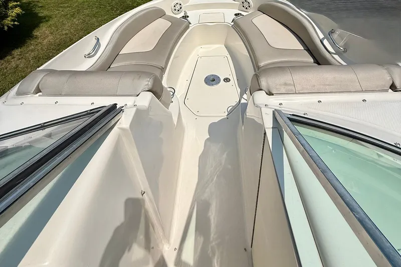 Slide: The Image of 2005 Sea Ray 270 Sundeck boat interior with cushioned seating and open deck layout. - 14