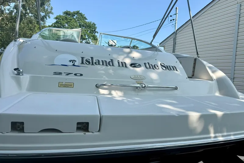 Slide: The Image of 2005 Sea Ray 270 Sundeck boat with "Island in the Sun" text on the stern. - 3