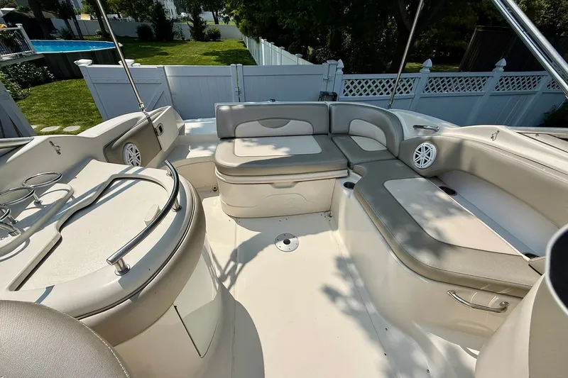 Slide: The Image of 2005 Sea Ray 270 Sundeck boat interior with spacious seating and cup holders. - 23
