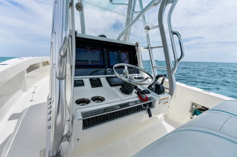 Slide: The Image of 2020 SeaVee 340Z boat cockpit with steering wheel and ocean view. - 49