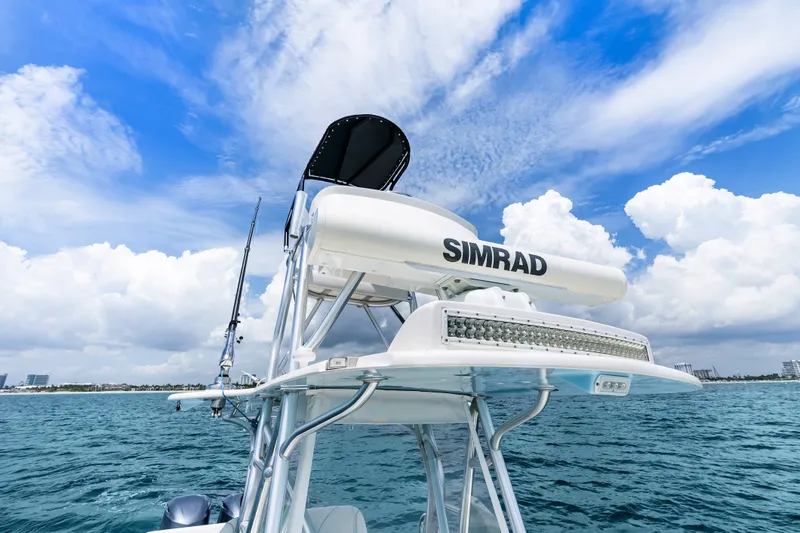 Slide: The Image of 2020 SeaVee 340Z boat with Simrad equipment on open water under blue sky. - 25