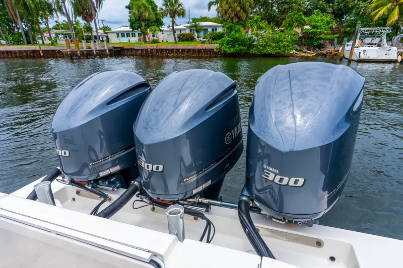 Slide: The Image of Triple Yamaha 300 engines on a 2020 SeaVee 340Z boat, docked by lush greenery. - 39