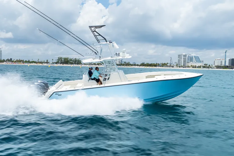 Slide: The Image of 2020 SeaVee 340Z boat cruising on blue ocean near city skyline. - 5