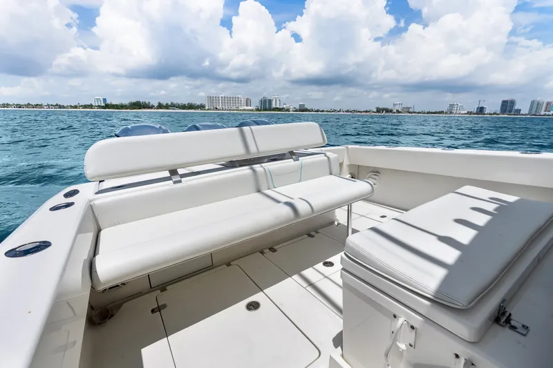 Slide: The Image of 2020 SeaVee 340Z boat interior with white seating, ocean view, and city skyline. - 26