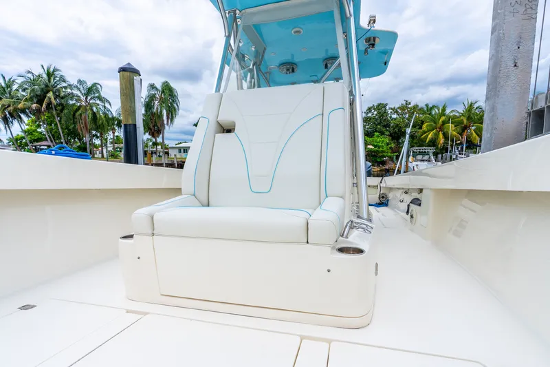 Slide: The Image of 2020 SeaVee 340Z boat with white seating, blue accents, and palm trees in the background. - 29