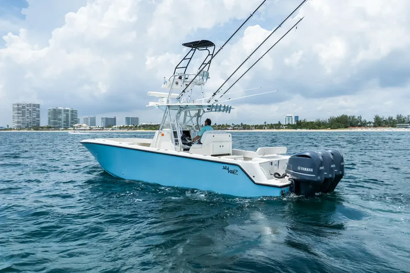Slide: The Image of 2020 SeaVee 340Z boat cruising on ocean with city skyline in background. - 3