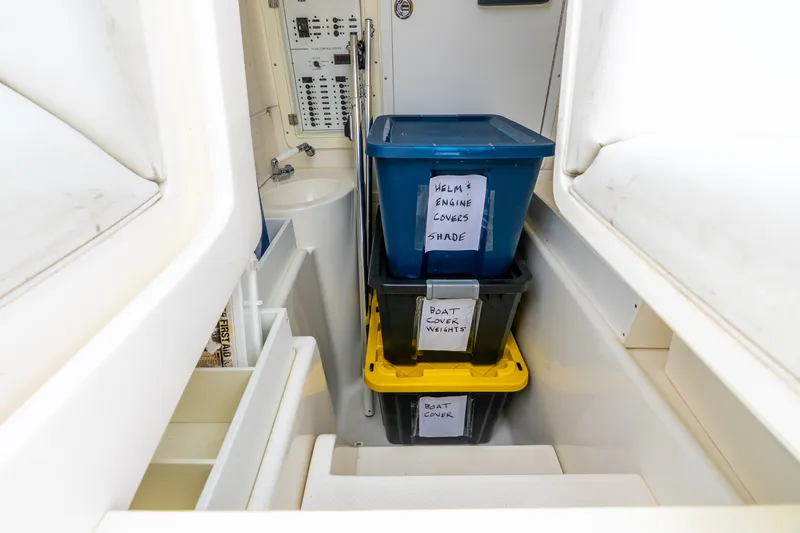 Slide: The Image of Storage area inside 2020 SeaVee 340Z boat with labeled containers and control panel. - 30