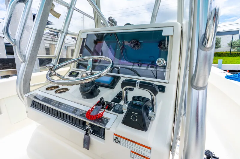 Slide: The Image of 2020 SeaVee 340Z boat helm with steering wheel and control panel. - 43