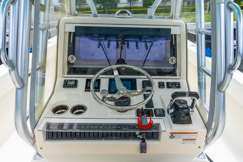 Slide: The Image of 2020 SeaVee 340Z boat helm with steering wheel and navigation controls. - 44
