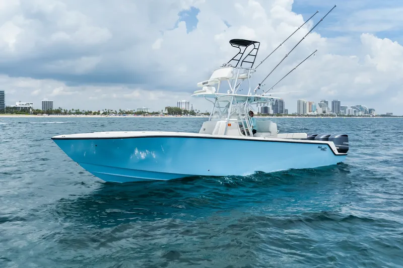 The Image of 2020 SeaVee 340Z boat on ocean, clear sky, city skyline in background. - 1