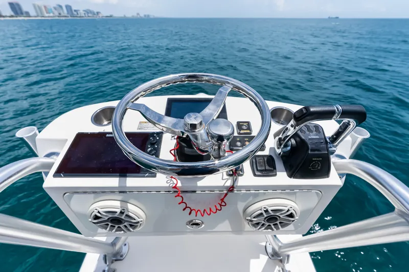 Slide: The Image of Helm of 2020 SeaVee 340Z boat with steering wheel and controls, overlooking ocean. - 55