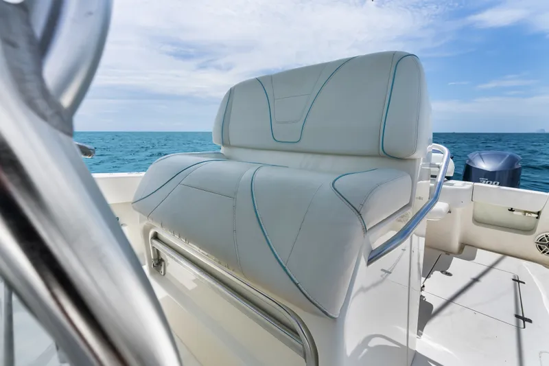 Slide: The Image of 2020 SeaVee 340Z boat with cushioned seating, ocean backdrop, and clear sky. - 51
