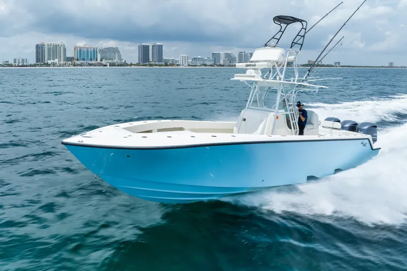 Slide: The Image of 2020 SeaVee 340Z boat cruising on ocean with city skyline in background. - 16