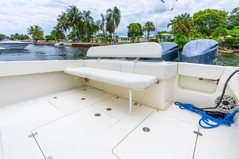 Slide: The Image of 2020 SeaVee 340Z boat deck with seating, twin engines, and scenic waterfront view. - 38