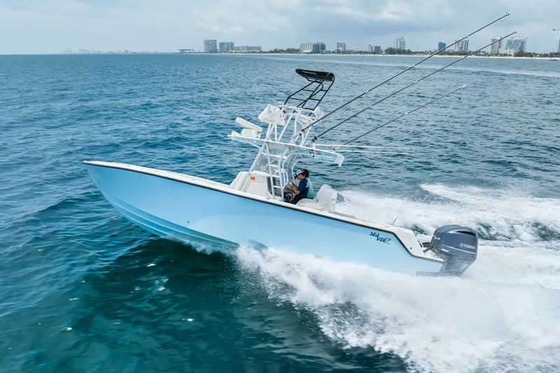 Slide: The Image of 2020 SeaVee 340Z boat cruising on ocean with fishing rods and Yamaha engines. - 7