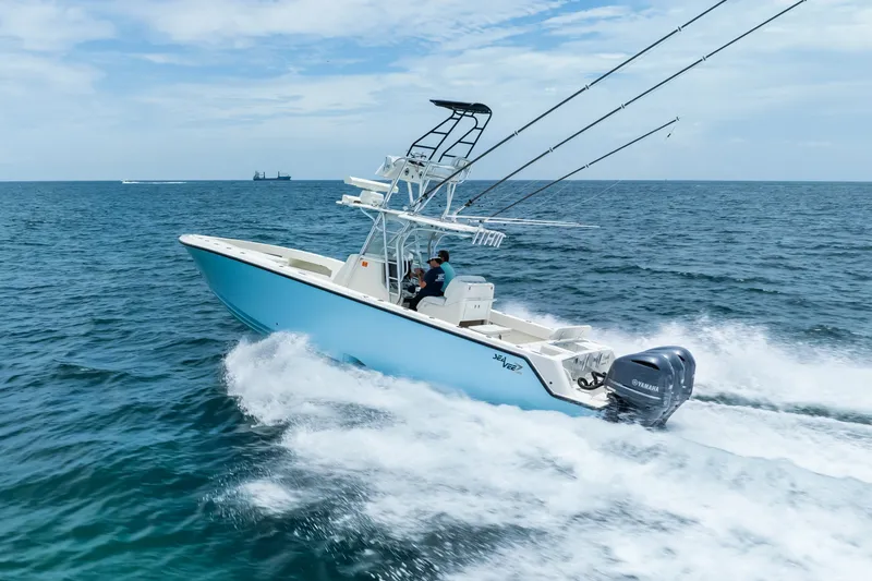 Slide: The Image of 2020 SeaVee 340Z boat cruising on open ocean with fishing rods and Yamaha engine. - 8