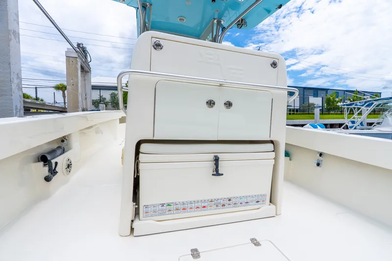 Slide: The Image of 2020 SeaVee 340Z boat interior with storage compartment and cooler under a blue sky. - 40