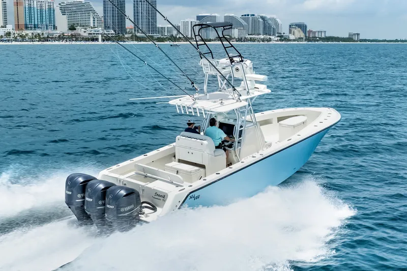 Slide: The Image of 2020 SeaVee 340Z boat cruising on ocean near city skyline. - 6
