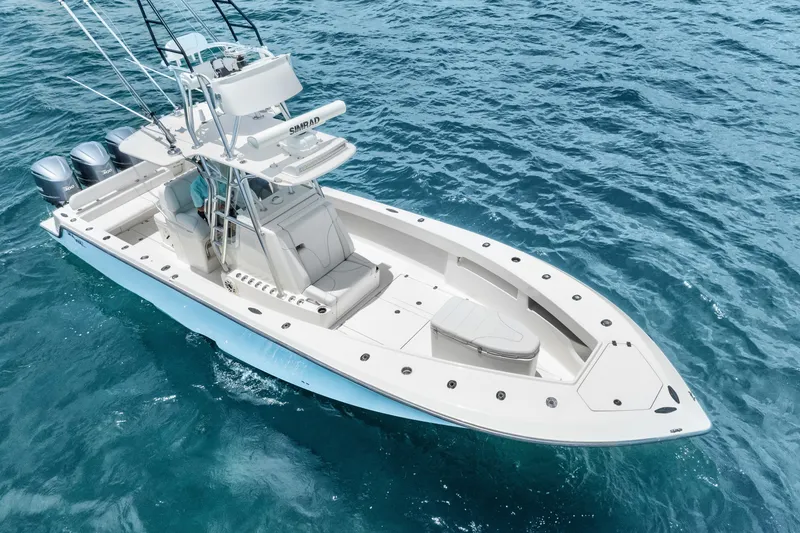 Slide: The Image of 2020 SeaVee 340Z boat on clear blue ocean water, featuring dual engines and sleek design. - 9