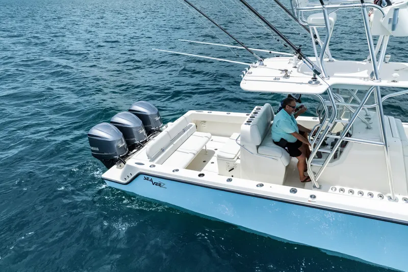Slide: The Image of 2020 SeaVee 340Z boat with triple Yamaha engines cruising on open water. - 14