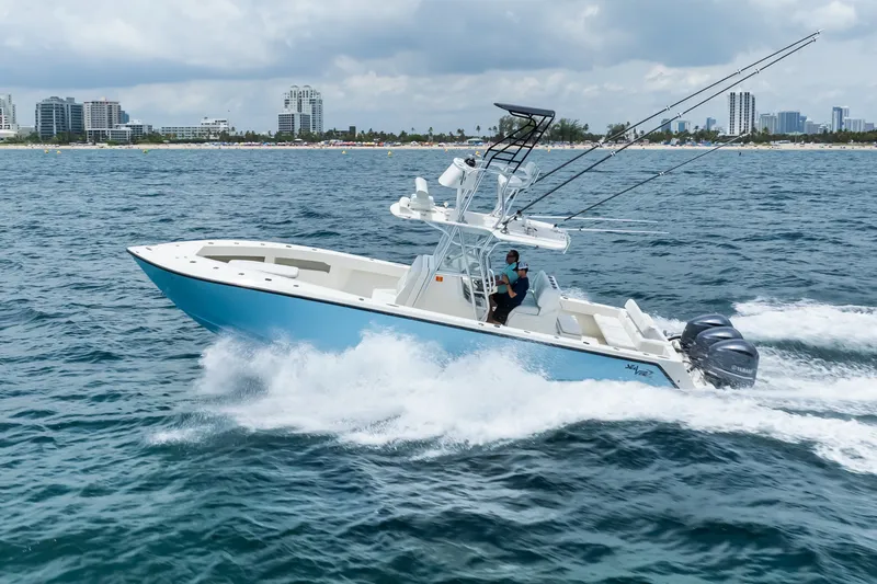 Slide: The Image of 2020 SeaVee 340Z boat cruising on ocean near city skyline. - 4