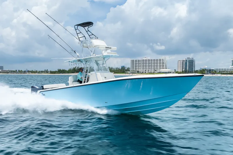 Slide: The Image of 2020 SeaVee 340Z boat cruising on ocean near city skyline. - 12