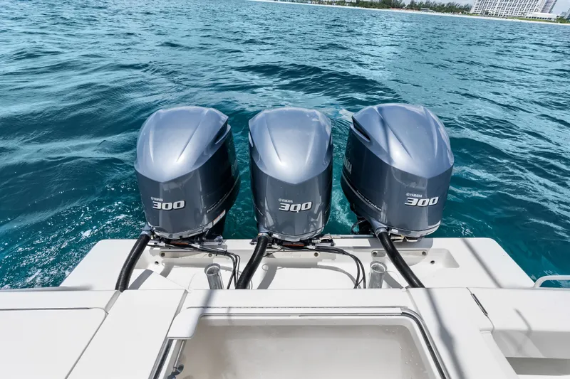 Slide: The Image of 2020 SeaVee 340Z boat with triple Yamaha 300 engines on open water. - 47