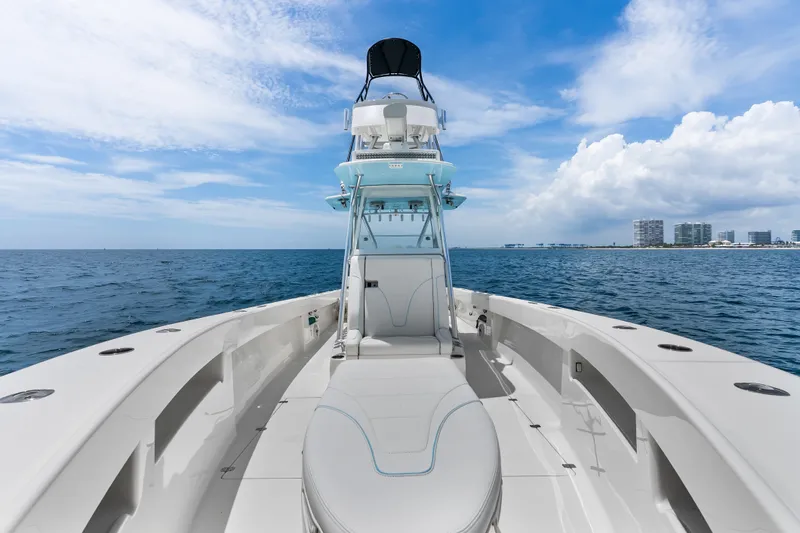 Slide: The Image of 2020 SeaVee 340Z boat on open water, clear sky, city skyline in background. - 21