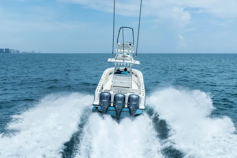 Slide: The Image of 2020 SeaVee 340Z boat cruising on open ocean with triple engines. - 15