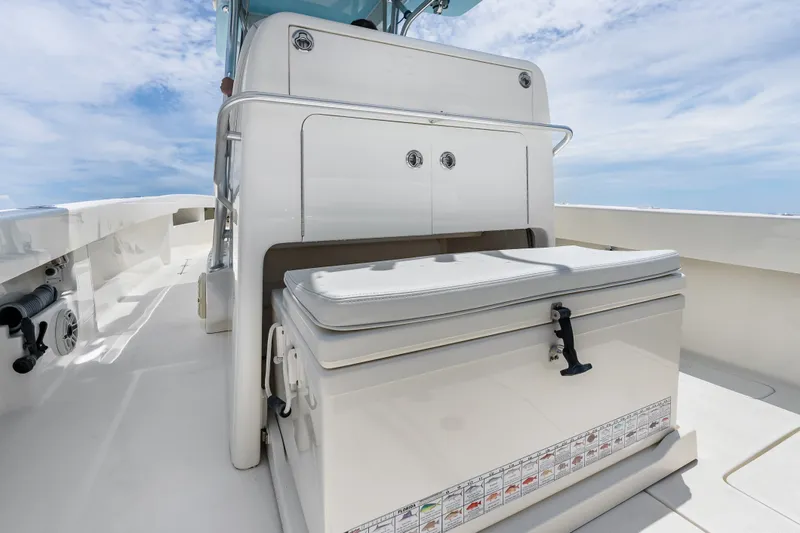 Slide: The Image of 2020 SeaVee 340Z boat deck with storage compartment and seating under clear blue sky. - 48