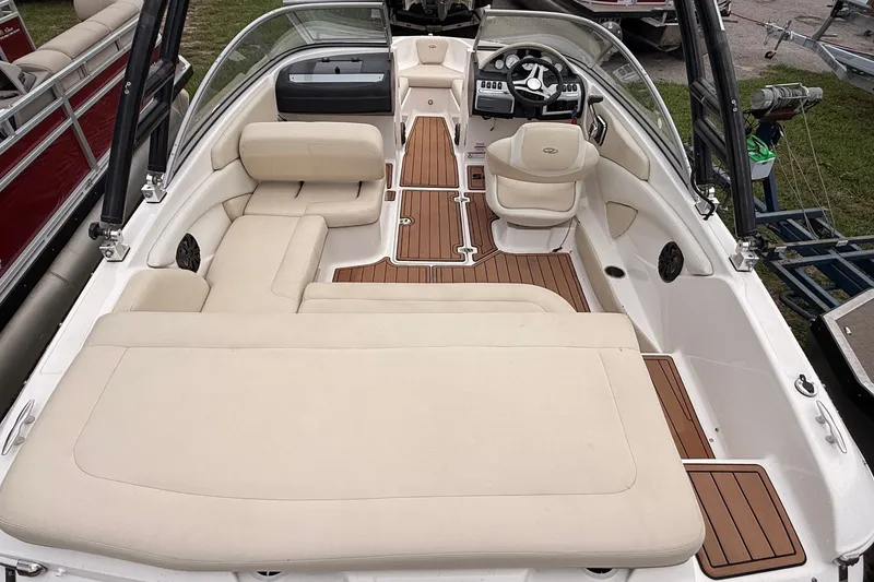 Slide: The Image of 2018 Regal 1900 ES Bowrider interior with beige seating and wood accents. - 6