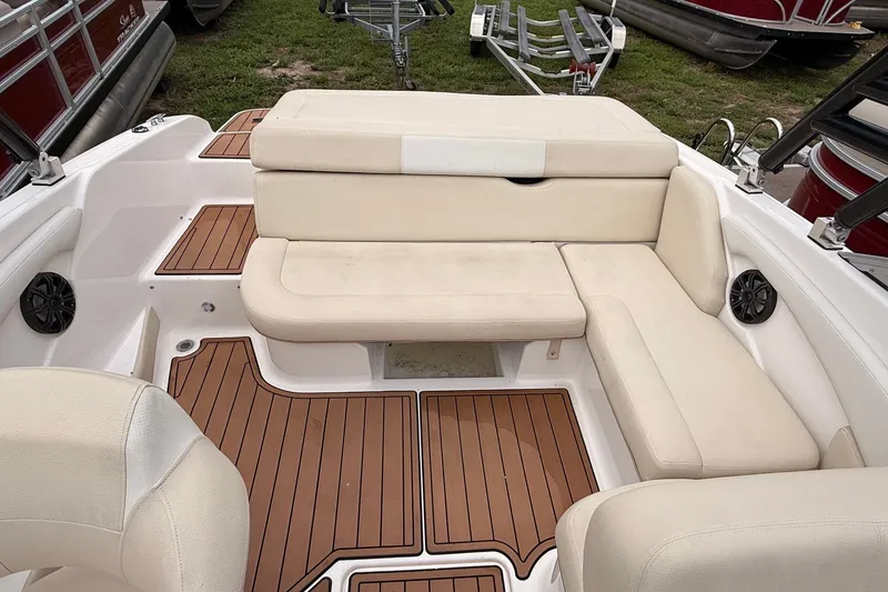 Slide: The Image of 2018 Regal 1900 ES Bowrider interior with beige seating and wood-style flooring. - 7