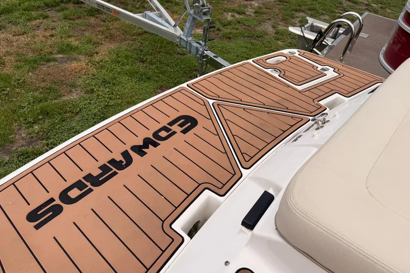 Slide: The Image of 2018 Regal 1900 ES Bowrider boat with custom deck flooring and trailer. - 9