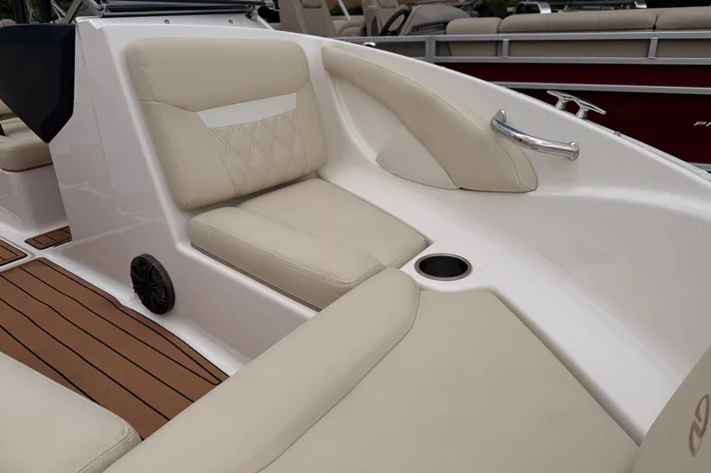 Slide: The Image of 2018 Regal 1900 ES Bowrider interior with beige seating and wood-style flooring. - 3