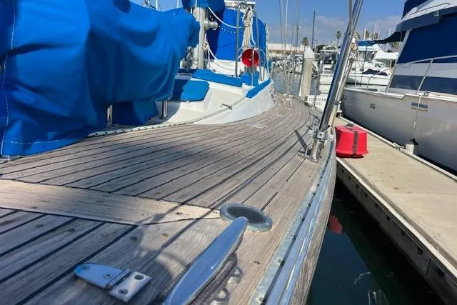 Slide: The Image of 1987 Tayana Vancouver 42 sailboat with wooden deck, docked at marina. - 2