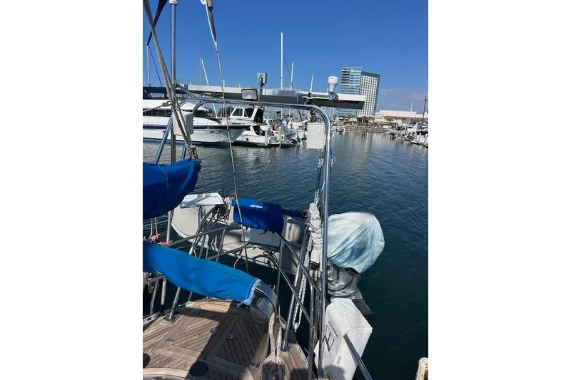 Slide: The Image of 1987 Tayana Vancouver 42 sailboat docked in a marina, with clear blue skies. - 36