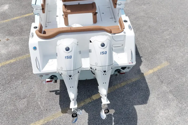 Slide: The Image of 2027 Sea Hunt Ultra 265SE boat with dual Yamaha 150 outboard engines, rear view. - 13