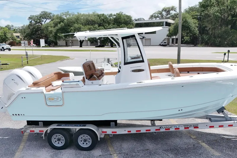 The Image of 2027 Sea Hunt Ultra 265SE boat on trailer, featuring sleek design and dual engines. - 0