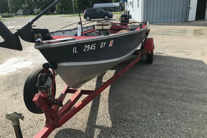 Slide: The Image of 1989 Lund 16 Pike SS boat on red trailer in parking lot. - 20