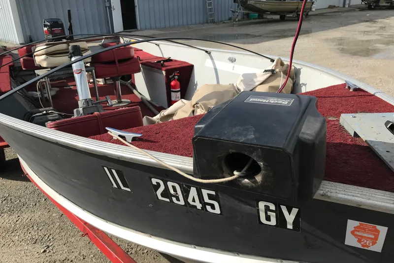 Slide: The Image of 1989 Lund 16 Pike SS boat with red interior and visible registration number. - 15