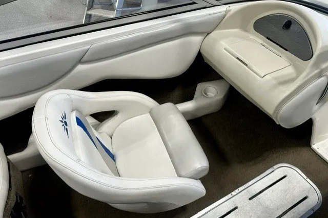 Slide: The Image of Interior of a 2007 Mariah SX18 boat featuring white seating and dashboard. - 13
