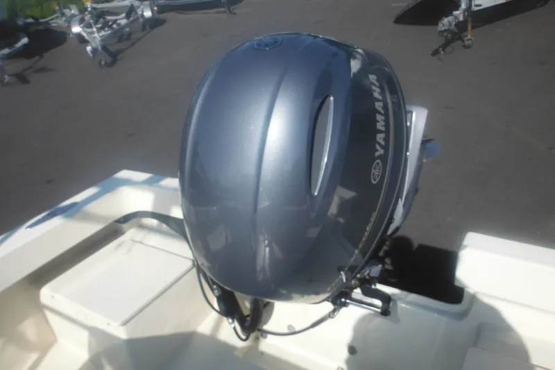 Slide: The Image of 2001 Parker 1801 Center Console boat with Yamaha outboard motor, parked on pavement. - 13